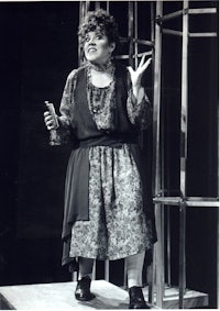 a woman in a dress standing on a stage