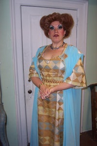 a woman in a costume standing in front of a door