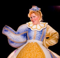 a woman dressed as cinderella is posing for a photo