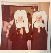 two nuns dressed as nuns pose for a photo