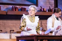 a woman in an apron is standing next to a man in an apron
