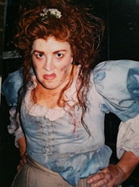 a woman in a blue dress is posing for a photo