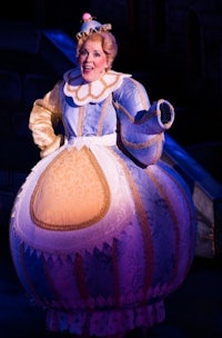 a woman dressed as cinderella on stage