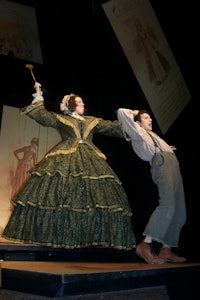 a man and a woman in a costume on a stage